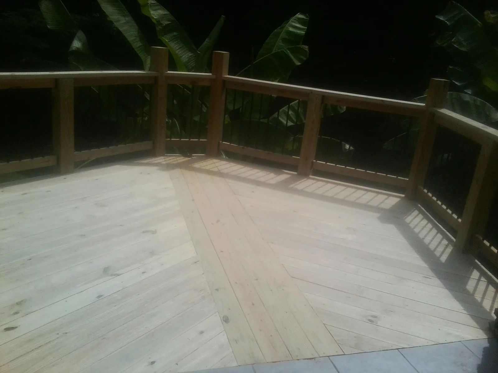 New wood deck and railing built off the back of a home in La Canada Flintridge