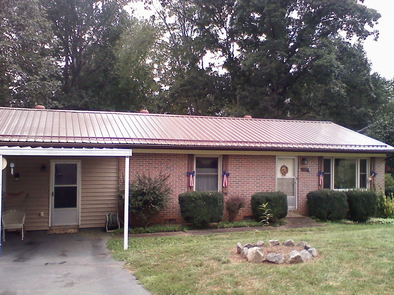 Bronze metal roof and carport on a brick ranch home — Roof Repair work by our crew in La Canada Flintridge